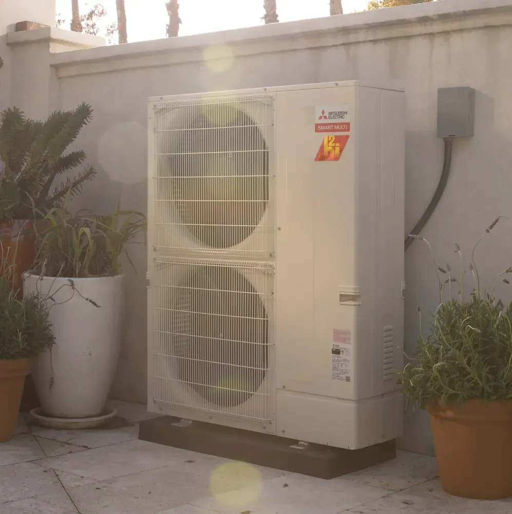 A Mitsubishi H2i Hyper Heat outdoor unit on a patio