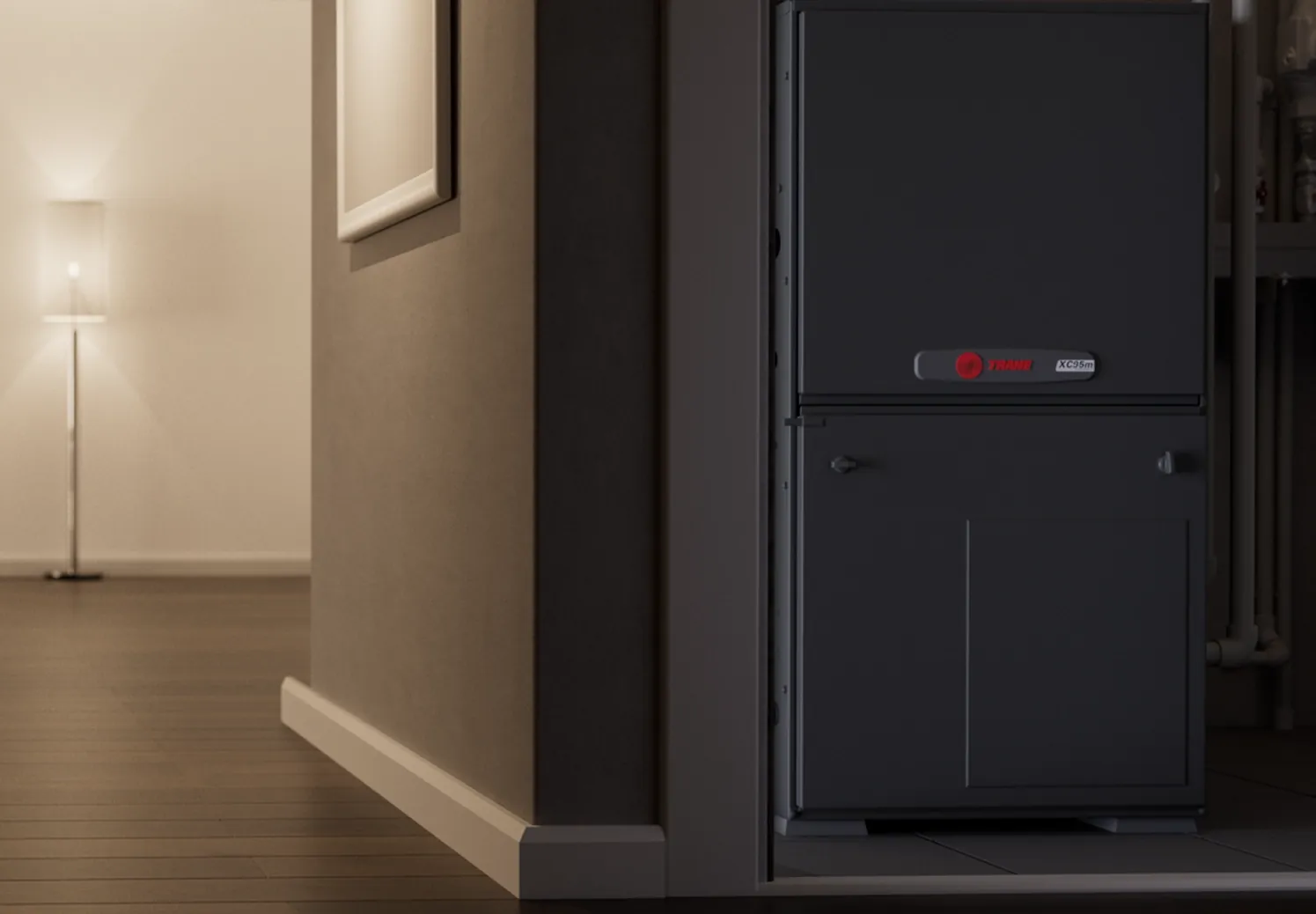 A Trane XC95M furnace running in a dim evening hallway
