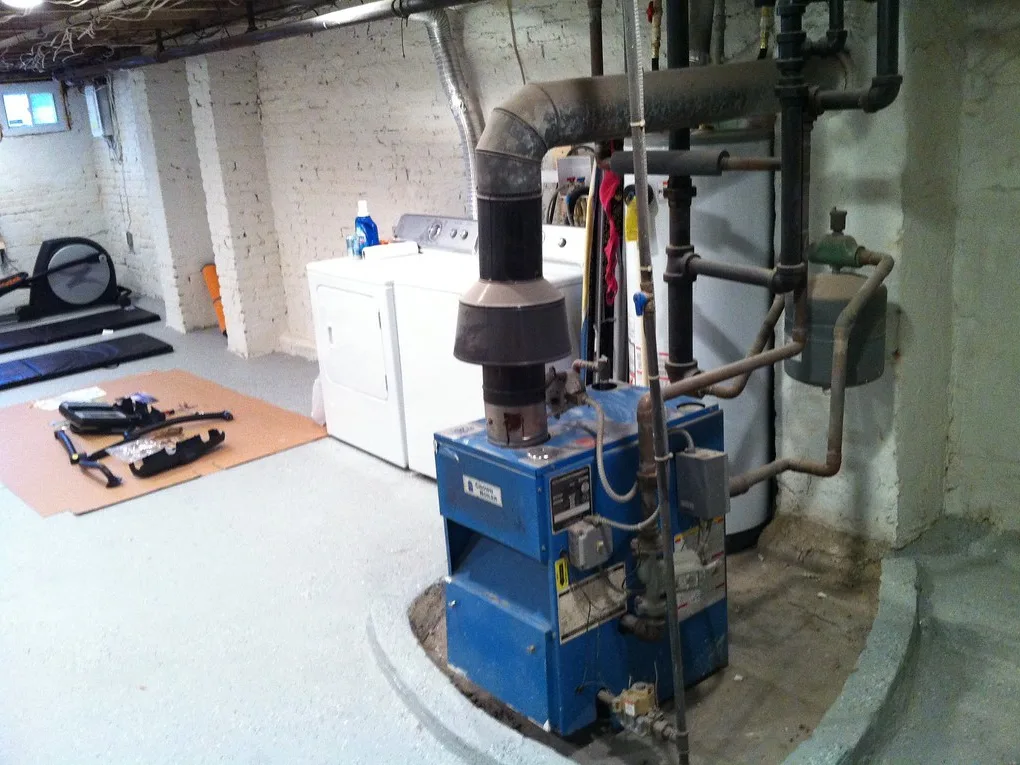 A gas furnace in a basement mechanical room