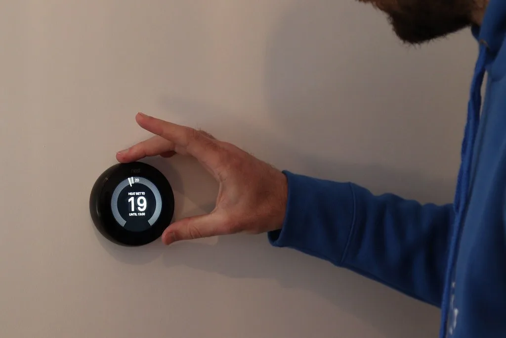 A smart thermostat mounted on a wall